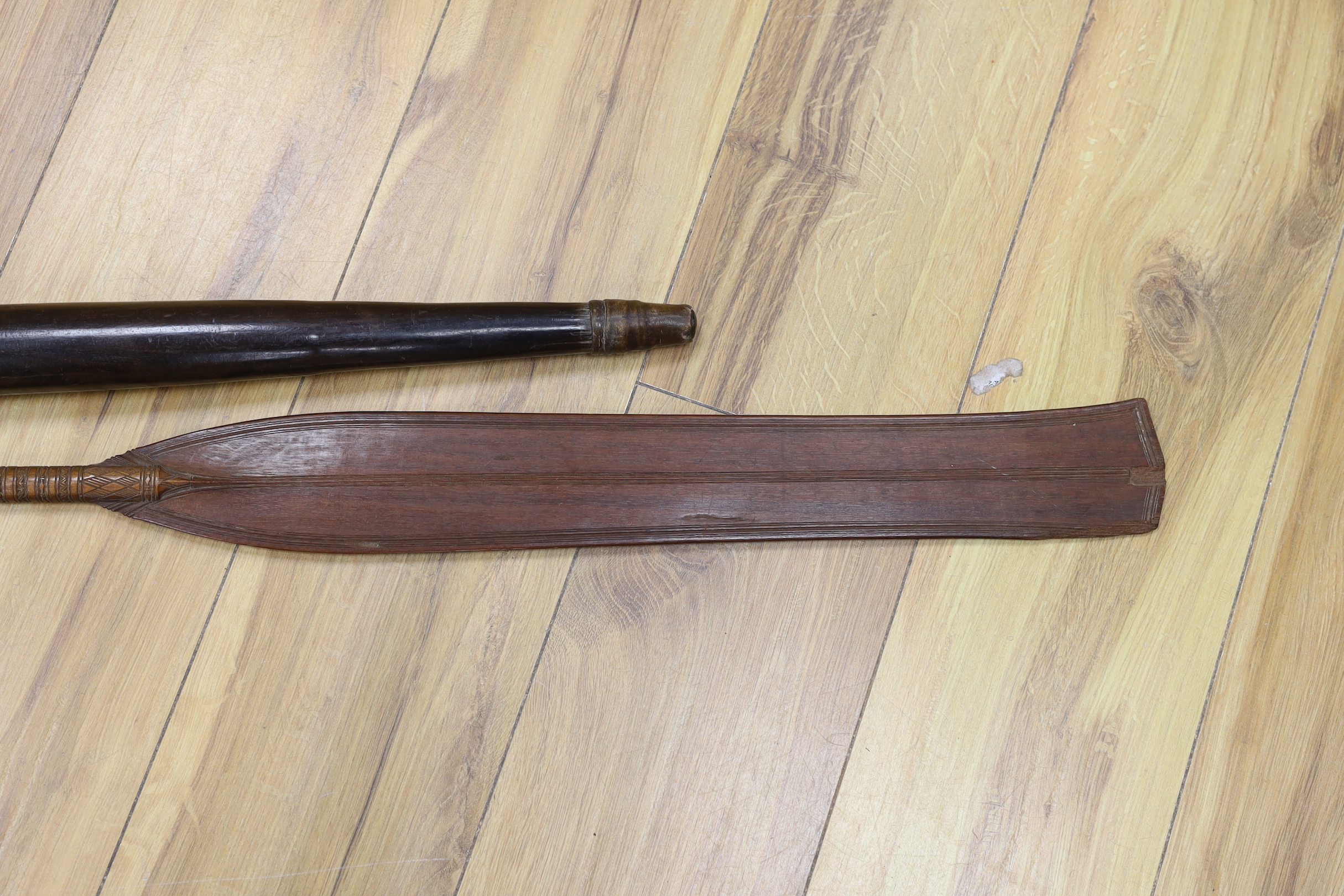 A 19th century Polynesian throwing club, possibly Fiji, and a 19th century ornamental Sri Lankan lady's paddle, 109cm long (2)